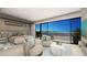 Serene primary bedroom with lake views, comfortable seating, and modern decor at 32 Heron Harbour Dr, Henderson, NV 89011