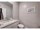 Cozy half-bath with a modern vanity, neutral tones, and stylish decor at 3358 Via Strada St, Henderson, NV 89044