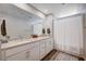 Bright bathroom featuring double sinks, modern fixtures, and a shower with a curtain at 3358 Via Strada St, Henderson, NV 89044
