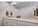Bathroom boasts double sinks with white cabinets and a large mirror, offering ample space at 3358 Via Strada St, Henderson, NV 89044