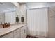 Well-lit bathroom featuring a shower with curtain, a single sink, and wood-look flooring at 3358 Via Strada St, Henderson, NV 89044