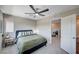 Modern bedroom with a ceiling fan and view into the bathroom at 3358 Via Strada St, Henderson, NV 89044