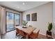 Dining area with modern decor, rustic table, comfortable seating, and sliding doors at 3358 Via Strada St, Henderson, NV 89044