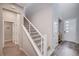 Hallway with a staircase featuring contemporary railing and view of the front door at 3358 Via Strada St, Henderson, NV 89044