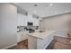 Beautiful kitchen featuring stainless steel appliances, white cabinets, and a large island at 3358 Via Strada St, Henderson, NV 89044