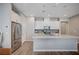 Modern kitchen with white cabinets, stainless steel appliances, and a large island at 3358 Via Strada St, Henderson, NV 89044