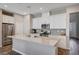 Bright kitchen with white cabinets, stainless steel appliances and a large kitchen island at 3358 Via Strada St, Henderson, NV 89044