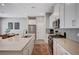 Modern kitchen with stainless steel appliances, white cabinetry, and quartz countertops at 3358 Via Strada St, Henderson, NV 89044
