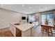 Open-concept living room with an island, modern furniture, and ample natural light at 3358 Via Strada St, Henderson, NV 89044