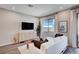 Comfortable living room featuring a large television, modern furniture, and plenty of natural light at 3358 Via Strada St, Henderson, NV 89044