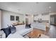Open-concept living area with a sofa, dining table, and a sleek, modern kitchen at 3358 Via Strada St, Henderson, NV 89044