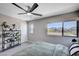 Bright main bedroom featuring a large window, greenery, and neutral color scheme at 3358 Via Strada St, Henderson, NV 89044