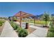 Community pavilion with seating amidst lush landscaping offers shade and space for gatherings, enhancing community living at 3358 Via Strada St, Henderson, NV 89044