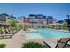 Sparkling community pool area offers lounge chairs, umbrellas and green landscaping, enhancing community recreation and relaxation at 3358 Via Strada St, Henderson, NV 89044
