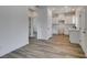 Open-concept floor plan featuring a kitchen with white cabinets and light-colored wood floors at 383 N 16Th St, Las Vegas, NV 89101