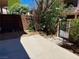 Private backyard boasts a spacious concrete patio, mature trees and gated access to common areas at 4338 Caliente St # 12, Las Vegas, NV 89119