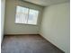 A bedroom with a window and neutral-colored carpet flooring at 4338 Caliente St # 12, Las Vegas, NV 89119