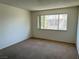 A bedroom with a window and neutral-colored carpet flooring at 4338 Caliente St # 12, Las Vegas, NV 89119