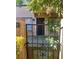 Inviting front entrance with secure gated access to the home's front porch and verdant landscaping at 4338 Caliente St # 12, Las Vegas, NV 89119