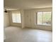Spacious living room with neutral tile flooring, vertical blinds, and a welcoming entryway at 4338 Caliente St # 12, Las Vegas, NV 89119