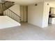 Inviting living room featuring neutral tile floors, staircase access and plenty of natural light at 4338 Caliente St # 12, Las Vegas, NV 89119