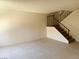 Bright living room featuring neutral tile floors and staircase access to the upper level at 4338 Caliente St # 12, Las Vegas, NV 89119