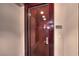 Elegant wood front door with modern hardware and unit number, offering a secure and stylish entrance at 4575 Dean Martin Dr # 1112, Las Vegas, NV 89103