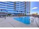 Outdoor swimming pool with surrounding chairs and tables at 4575 Dean Martin Dr # 1112, Las Vegas, NV 89103