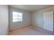Bright bedroom with neutral walls, carpeted floors, and natural light from a window at 4990 River Glen Dr # 171, Las Vegas, NV 89103