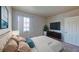 Cozy bedroom featuring a plush bed, large window, and a sleek entertainment center at 4990 River Glen Dr # 171, Las Vegas, NV 89103