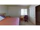 Bright bedroom with a queen-sized bed, desk, and ample closet space at 4990 River Glen Dr # 171, Las Vegas, NV 89103