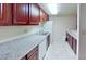 Functional kitchen with sleek granite countertops, white appliances, and ample cabinetry at 4990 River Glen Dr # 171, Las Vegas, NV 89103