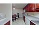 Efficient kitchen with white appliances, granite countertops, and an adjacent dining area at 4990 River Glen Dr # 171, Las Vegas, NV 89103