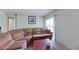 Spacious living room featuring a large sectional couch, sliding glass door, and neutral tones at 4990 River Glen Dr # 171, Las Vegas, NV 89103