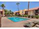 Inviting community pool area with lounge chairs, palm trees, and well-kept landscaping at 4990 River Glen Dr # 171, Las Vegas, NV 89103