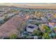 Beautiful aerial view shows a community featuring homes with pools and solar panels at 53 Precipice Ct, Henderson, NV 89002