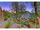 Expansive backyard featuring a lush lawn, mature trees, a playground, and a sparkling pool at 53 Precipice Ct, Henderson, NV 89002