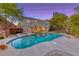 Inviting backyard features a sparkling pool, spa, and lush landscaping perfect for outdoor entertaining at 53 Precipice Ct, Henderson, NV 89002
