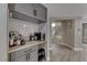 Functional butler's pantry with custom cabinets, bar area, and convenient access to the kitchen and dining areas at 53 Precipice Ct, Henderson, NV 89002