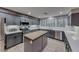Modern kitchen with stainless steel appliances, center island, and custom cabinets at 53 Precipice Ct, Henderson, NV 89002