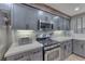 Modern kitchen featuring gray cabinetry, stainless steel appliances, and a gas range at 53 Precipice Ct, Henderson, NV 89002