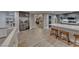 Open-concept living area showcasing kitchen, dining, and a staircase with gray cabinets and modern flooring at 53 Precipice Ct, Henderson, NV 89002