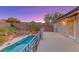 Backyard pool with patio deck during sunset with mountain views at 53 Precipice Ct, Henderson, NV 89002