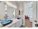 Bathroom with double blue vessel sinks, marble counters, and a view into the bedroom at 5913 Audria Falls Ave, Las Vegas, NV 89131