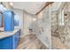 Beautiful bathroom with stylish blue cabinets, grey countertops and a walk-in shower at 5913 Audria Falls Ave, Las Vegas, NV 89131