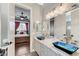 Bathroom with double blue vessel sinks, marble counters, and a view into the bedroom at 5913 Audria Falls Ave, Las Vegas, NV 89131