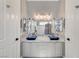 Elegant bathroom featuring double sinks, a marble countertop, and modern fixtures at 5913 Audria Falls Ave, Las Vegas, NV 89131
