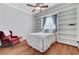 Comfortable bedroom featuring built-in shelving, wood floors and a cozy red chair at 5913 Audria Falls Ave, Las Vegas, NV 89131