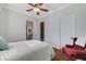 Bright bedroom with wood floors featuring a cozy chair, and an ensuite bath for convenience at 5913 Audria Falls Ave, Las Vegas, NV 89131