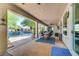 Relaxing covered patio with views of the pool, lush landscaping, and outdoor dining area at 5913 Audria Falls Ave, Las Vegas, NV 89131